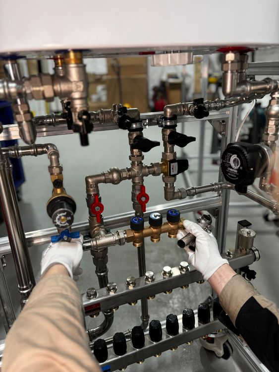 Professional plumber servicing industrial pipe system in Austin