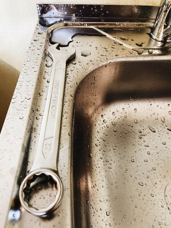  An image of a spanner on a sink