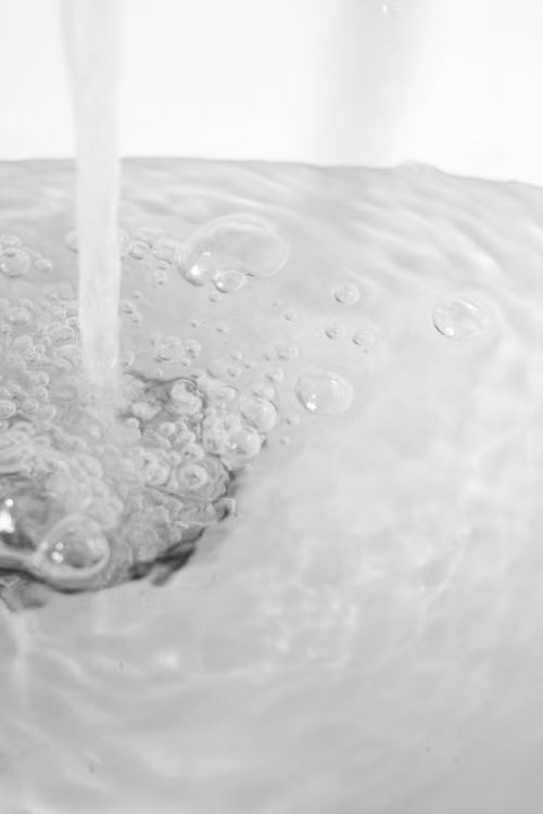 Water running from a faucet into a sink