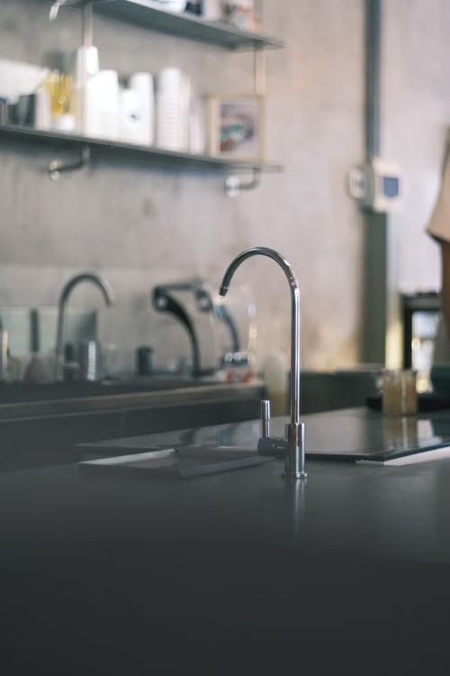 Chrome faucet and sink in a modern commercial kitchen
